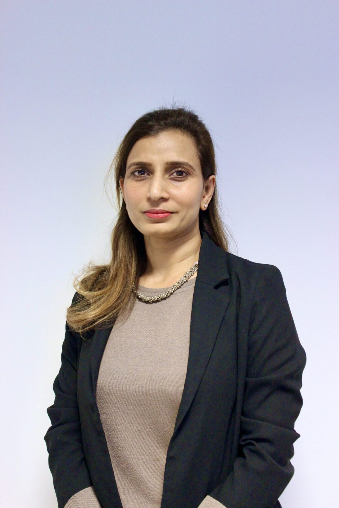 Ishrat Khan, Head of Compliance at Exchange Legal Services, depicted in a professional context, showcasing her expertise in banking and regulatory compliance.